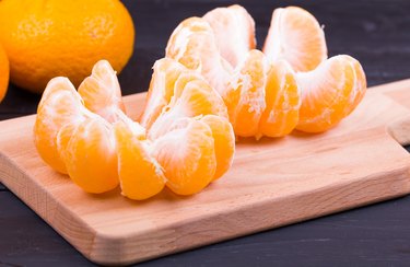 The tangerines peeled on a chopping board