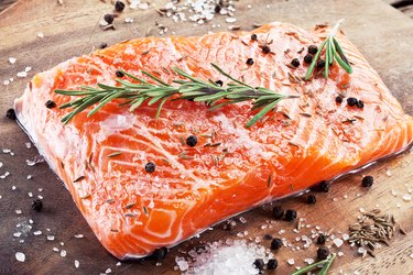 Salmon filet on a wooden carving board.