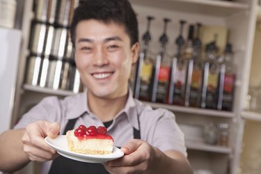 Portrait of barista serving cheesecake