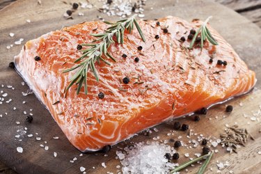 Salmon filet on a wooden carving board.