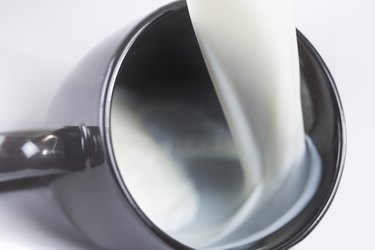 Milk flowing into a mug