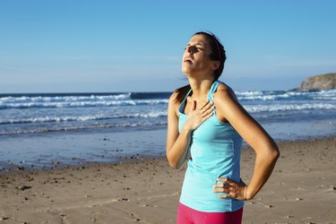 Exhausted female runner suffering angina pectoris