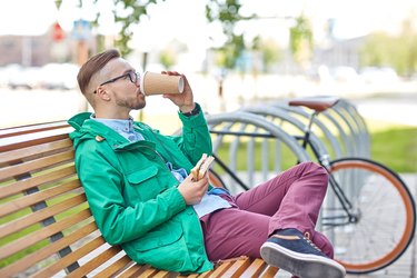 happy young hipster man with coffee and sandwich