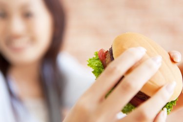 Young woman eating a hamburger