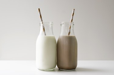 milk jugs regular and chocolate touching on white