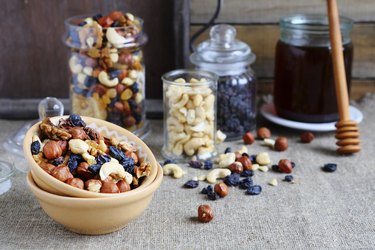 mixed nuts in a bowl and jars on a table