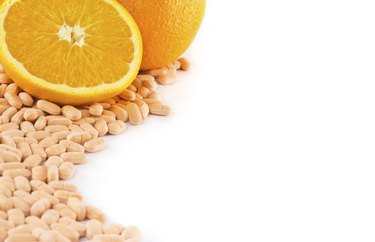 Orange fruit with vitamin c tablet