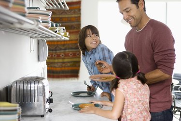 Father in kitchen with children (6-10)