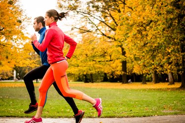 Couple jogging in autumn nature