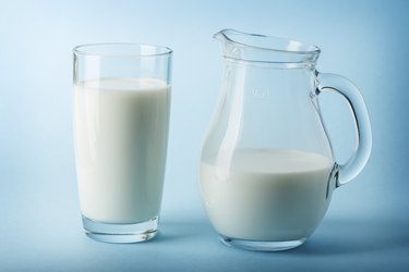 Glass jug and glass with milk