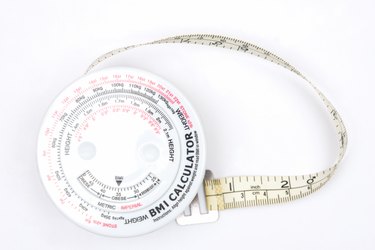 body mass index calculator on white counter