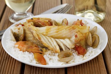 fish with seafood and rice on the plate