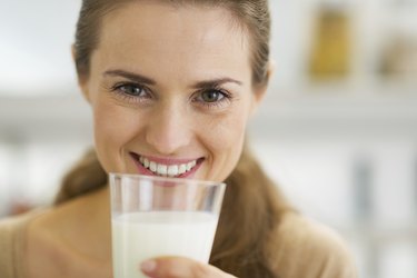 happy young woman drinking milk