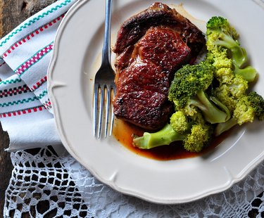 Grilled ribeye steak with boiled broccoli in olive oil