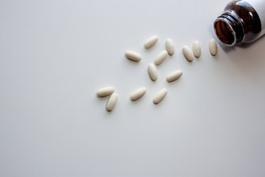 Pour off vitamin C on a white background