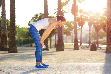 Tired woman resting after workout exercise