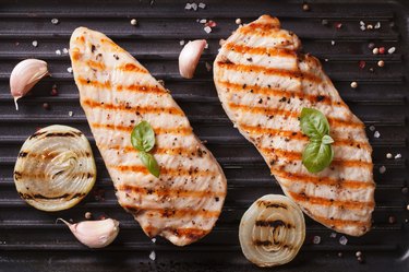 Grilled chicken on the grill close up horizontal top view