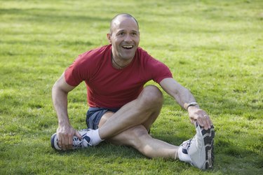 Hispanic man exercising in a park and smiling