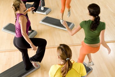 Women doing step aerobics