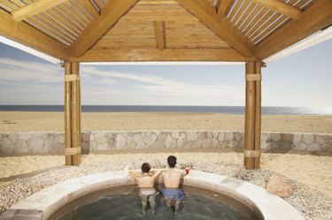 Couple in hot tub outdoors at beach resort