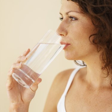 Close-up of a woman drinking glass of water
