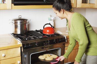 Young woman chopping fruit in the kitchen