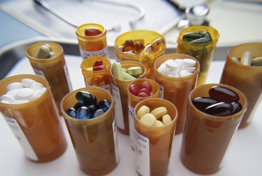 Close-up of an assortment of tablets and capsules in vials