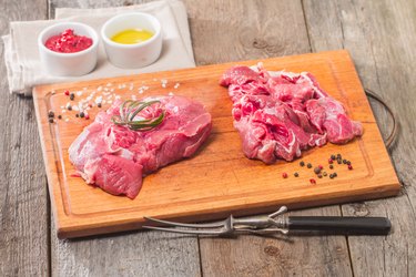 Raw meat  on wooden cutting board