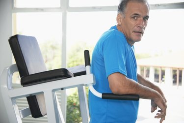 Mature man on exercise machine (portrait)