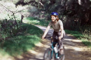 Woman riding mountain bike on a trail