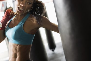 Woman hitting punching bag