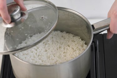 Covering a pan containing rice, close up