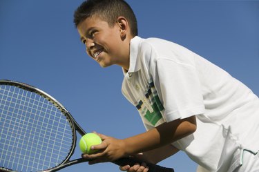 Young Tennis Player Preparing to Serve