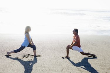 Couple stretching on beach