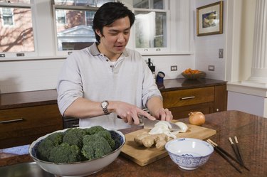 Man cutting vegetables in the kitchen