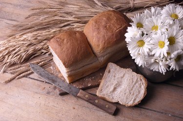 Daisies in rustic jug with bread loaf