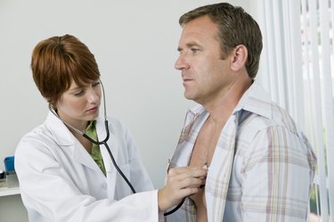 Doctor examining patient with stethoscope