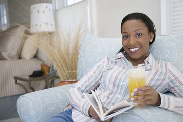 Woman holding a glass of juice and smiling
