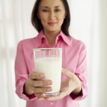 portrait of a woman holding a glass of milk