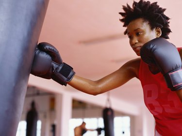 Low angle view of a young woman practicing boxing