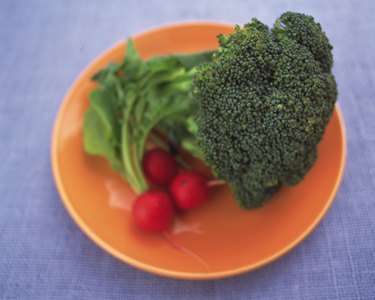Closed Up Image of a Broccoli and Some Radish On an Orange Plate, High Angle View, Differential Focus