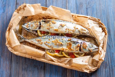 A baked whole mackerel with lemon, garlic, onion and tomatoes.