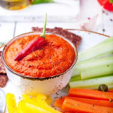 Roasted pepper dip, sauce, spread with fresh carrot, celery sticks