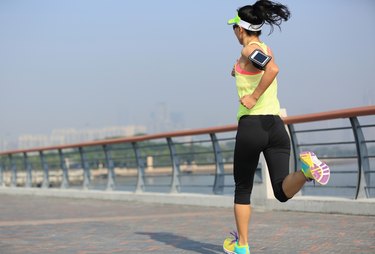 young fitness woman runner running at seaside