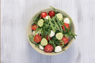 Green salad made with arugula, tomatoes, mozzarella