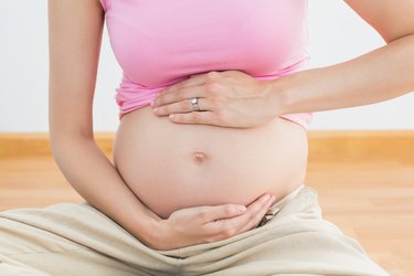 Pregnant woman holding her bump