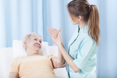 Elderly women having arm examination