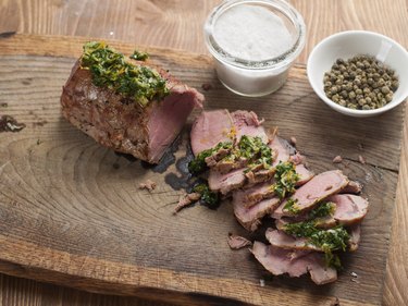 Beef tenderloin cooked in a convection oven on wooden board