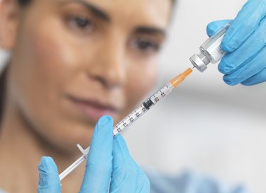 Close up of nurse preparing a syringe for an injection