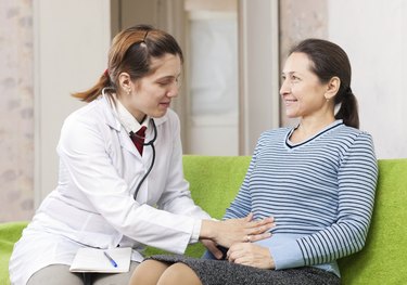 Woman doctor examining the patient in clinic